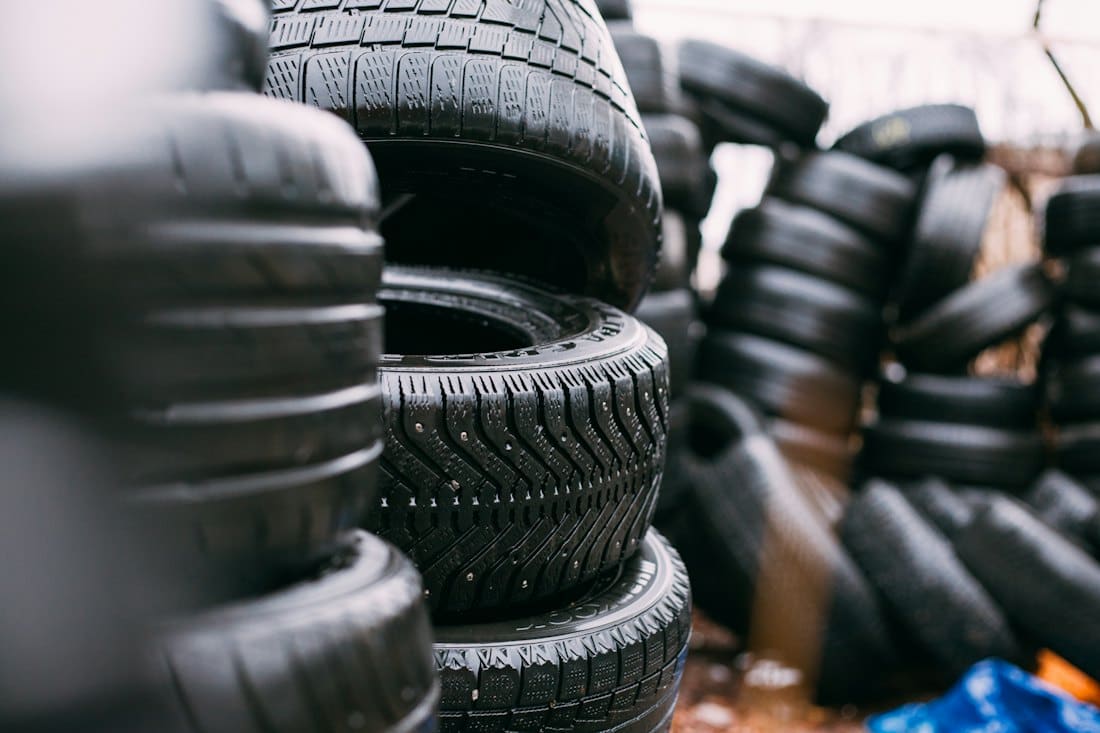 Stacks of new car tyres in a tyre bay