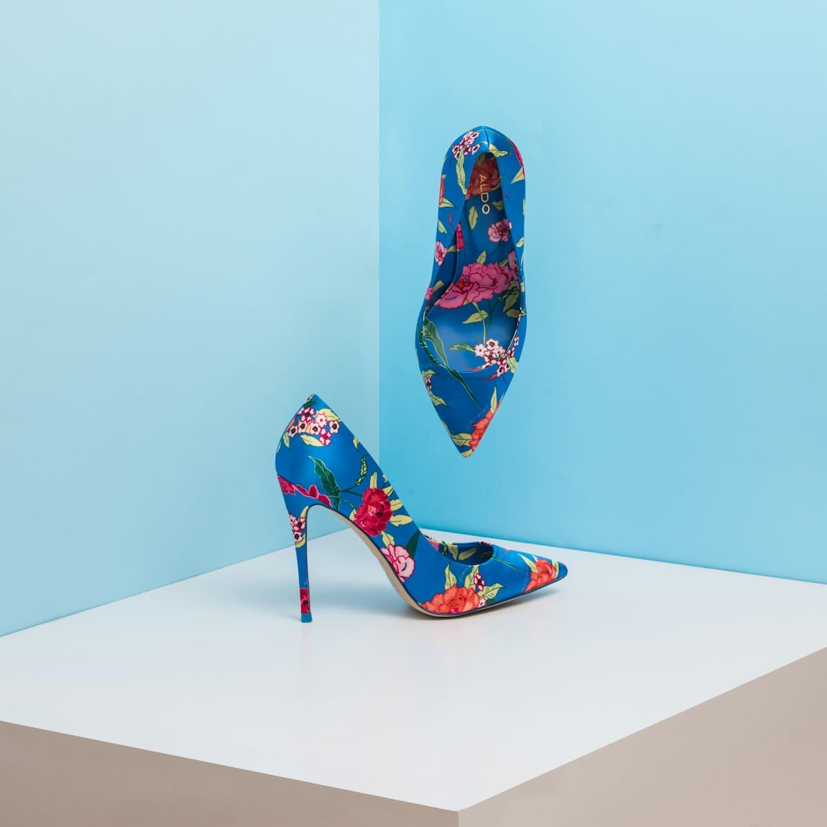 Pair of blue printed pointed pumps on a pale blue set