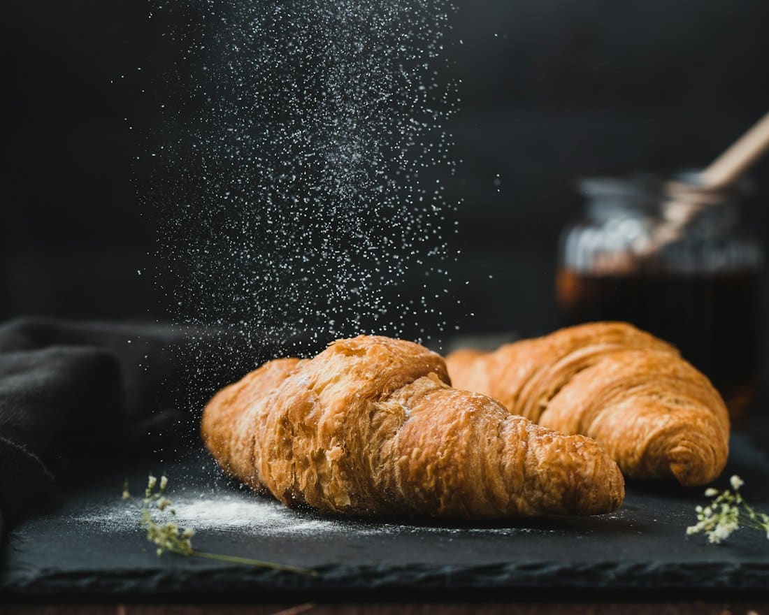Freshly baked croissants on a slate board