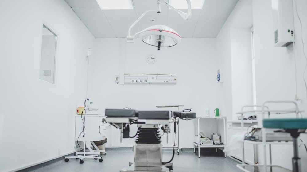 Clean, bright examination room with an exam bed and equipment