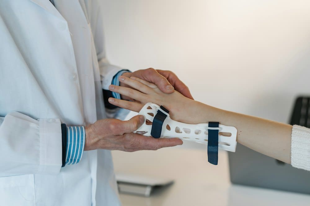 Clinician fitting a supportive wrist brace on a patient