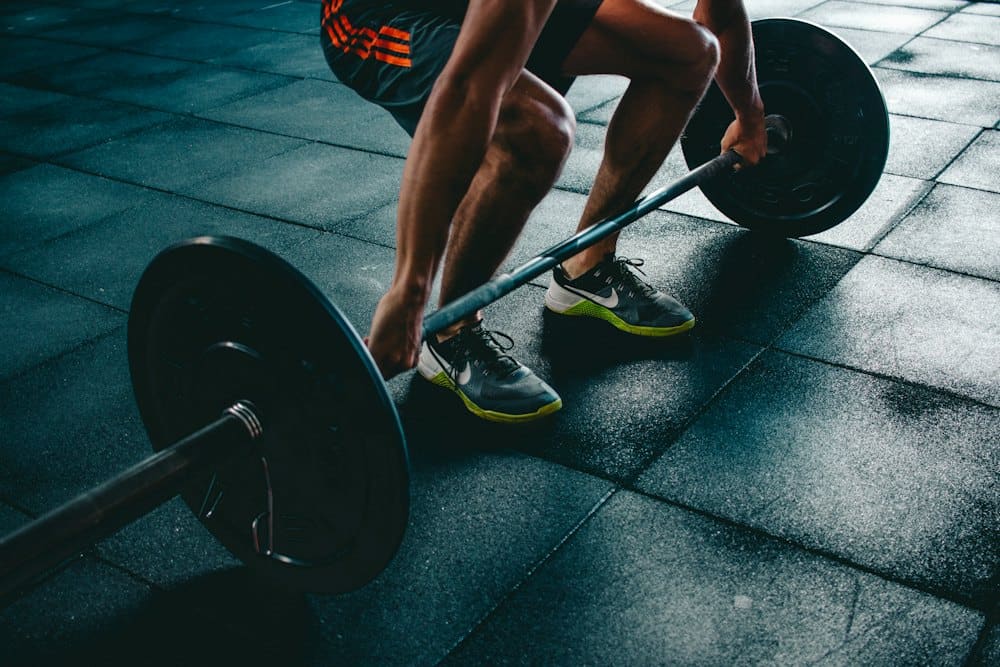 Athlete gripping a loaded barbell before a deadlift