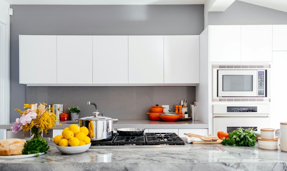 White kitchen with marble worktop and fresh produce